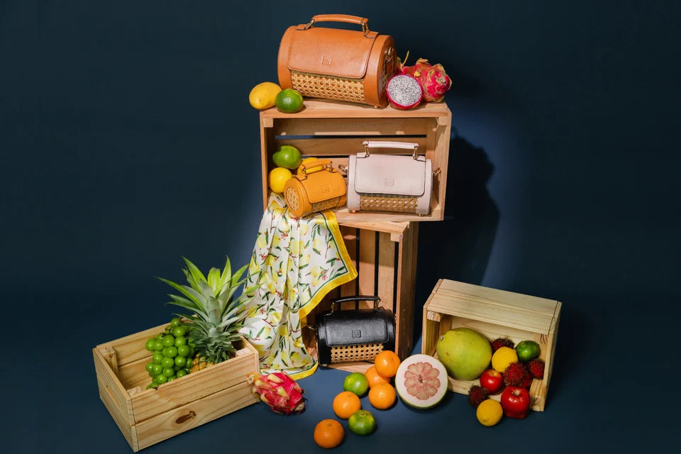 Solihiya Roller bags arranged with tropical fruit and wooden crates against navy